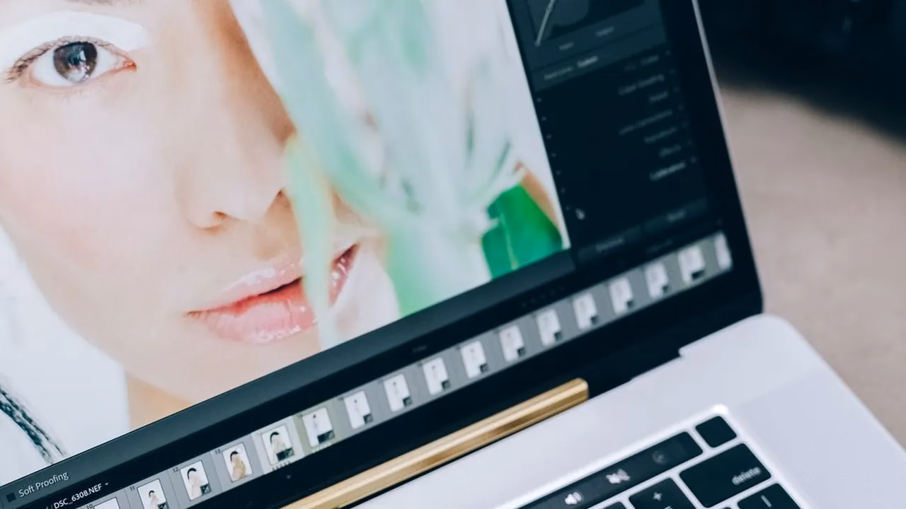 Laptop screen showing photo retouching software used to prepare images before conversion