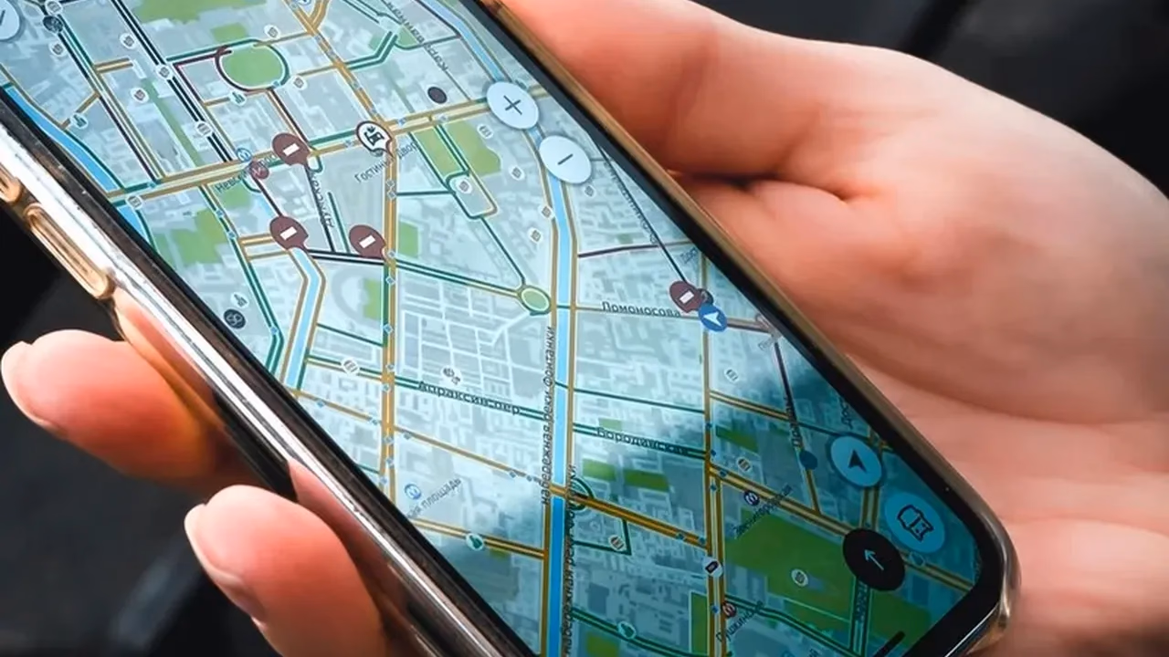 Hand holding a smartphone showing a street map, representing a local search on mobile