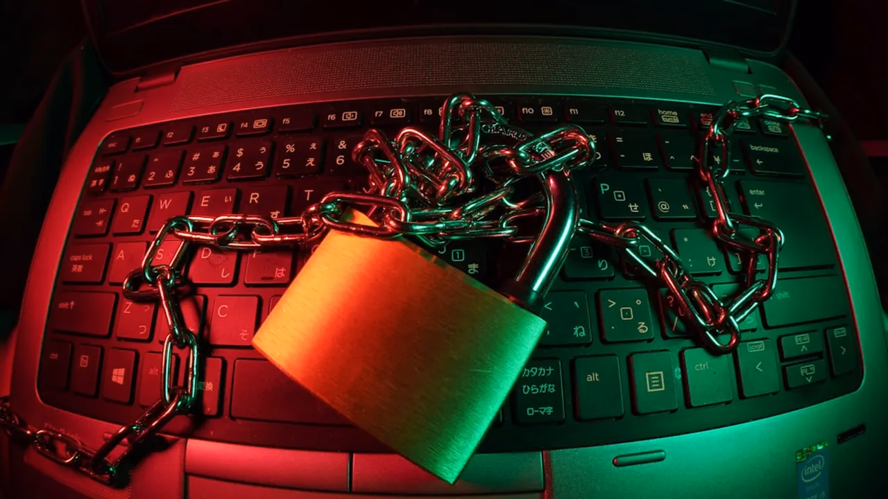 A padlock chained to a laptop keyboard, representing locked-down WordPress security